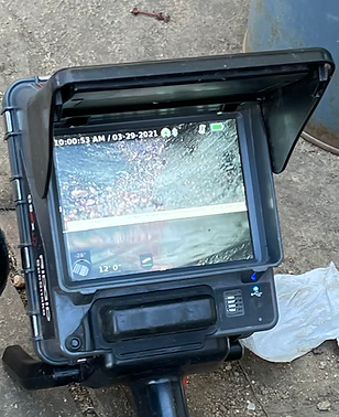 Sewer camera inspection monitor showing the inside of a drain line on a Drainline Services job
